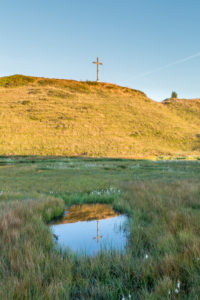 Summit, summit cross is reflected in lake, heaven Summit, summit cross is reflected in lake, heaven
